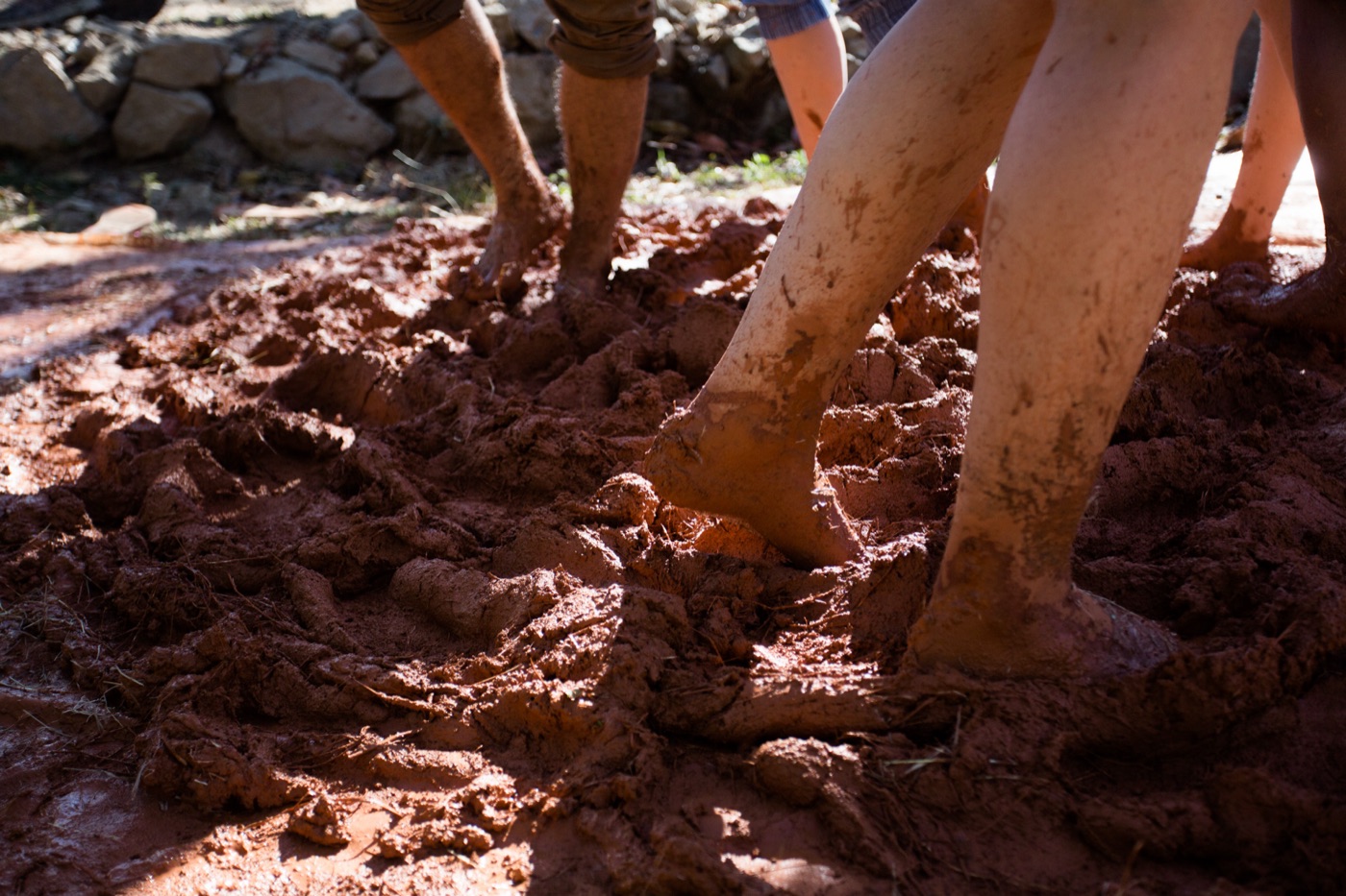 Mixing cob by foot for the build